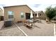 A gravel backyard featuring patio seating, desert landscaping and a fire pit at 4774 E Chromium Rd, San Tan Valley, AZ 85143