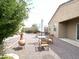 Backyard with desert landscaping including tables and chairs with shade umbrellas at 4774 E Chromium Rd, San Tan Valley, AZ 85143