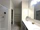 Bright bathroom features a walk-in shower, vanity area, and accessible shelves in the adjacent closet at 4774 E Chromium Rd, San Tan Valley, AZ 85143
