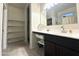 Bathroom vanity area featuring great storage with an adjacent walk-in closet and a large mirror at 4774 E Chromium Rd, San Tan Valley, AZ 85143