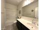 Well-lit bathroom featuring a shower-tub combo and a vanity with dark wood cabinets at 4774 E Chromium Rd, San Tan Valley, AZ 85143