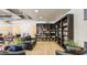 Cozy library with floor-to-ceiling bookshelves, comfortable seating, and laminate floors perfect for relaxing at 4774 E Chromium Rd, San Tan Valley, AZ 85143