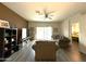 Cozy living room features wood flooring, a ceiling fan, and sliding glass doors to the backyard at 4774 E Chromium Rd, San Tan Valley, AZ 85143