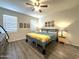 Comfortable bedroom with neutral walls, wood-look flooring, and windows for natural light at 4774 E Chromium Rd, San Tan Valley, AZ 85143