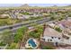 An elevated view of a neighborhood with mature trees and desert landscaping and mountain views at 5042 W Lariat Ln, Phoenix, AZ 85083