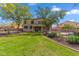 Spacious backyard features a grassy lawn, mature trees, and a fence enclosing the swimming pool at 5042 W Lariat Ln, Phoenix, AZ 85083