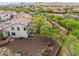 Aerial view of a home's landscaped backyard featuring desert landscaping, patio, privacy fence, and mature shade trees at 5042 W Lariat Ln, Phoenix, AZ 85083