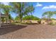 Expansive backyard with mature trees, landscaping, and seating area at 5042 W Lariat Ln, Phoenix, AZ 85083