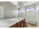 Bathroom features dual vanity, granite countertops, bathtub, tile flooring, and large mirror at 5042 W Lariat Ln, Phoenix, AZ 85083