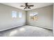 Neutral bedroom featuring carpet, ceiling fan, and three bright windows at 5042 W Lariat Ln, Phoenix, AZ 85083