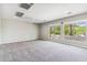 Bright bedroom with plush carpeting and ample natural light from the windows at 5042 W Lariat Ln, Phoenix, AZ 85083