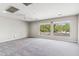Bright bedroom with plush carpeting and ample natural light from the windows at 5042 W Lariat Ln, Phoenix, AZ 85083