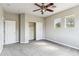 Neutral bedroom with closet, carpet, ceiling fan, and two bright windows at 5042 W Lariat Ln, Phoenix, AZ 85083