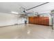 Spacious garage featuring storage cabinets and overhead lighting at 5042 W Lariat Ln, Phoenix, AZ 85083