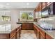 Well-lit kitchen boasts granite countertops, island, and wooden cabinetry at 5042 W Lariat Ln, Phoenix, AZ 85083