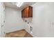 Laundry room with tile floors, overhead storage, and washer/dryer hookups at 5042 W Lariat Ln, Phoenix, AZ 85083