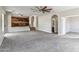 Spacious living room features an open floor plan with neutral walls and plush carpet at 5042 W Lariat Ln, Phoenix, AZ 85083