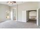 Spacious main bedroom featuring neutral paint, carpet, vaulted ceilings and ensuite bathroom at 5042 W Lariat Ln, Phoenix, AZ 85083