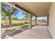 Covered patio overlooks a grassy yard, desert landscaping, and a private backyard at 5042 W Lariat Ln, Phoenix, AZ 85083