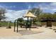 Community playground with swings, slide, and shade cover at 5042 W Lariat Ln, Phoenix, AZ 85083