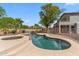 View of the backyard showcasing a refreshing in-ground pool and spa with desert landscaping at 5042 W Lariat Ln, Phoenix, AZ 85083