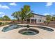 Backyard view of a dark blue pool with a hot tub, metal fence, desert landscaping, and a covered patio on the home at 5042 W Lariat Ln, Phoenix, AZ 85083