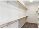 View of a walk-in closet featuring white walls, built-in shelves, and wood racks at 5042 W Lariat Ln, Phoenix, AZ 85083