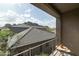Balcony with a table and chairs, perfect for enjoying the views of the neighboring rooftops and mountain backdrop at 5118 S Morning Sky Trl, Gold Canyon, AZ 85118