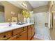 Bathroom featuring double sinks, wood cabinets, a large mirror, and a shower-tub combination at 5118 S Morning Sky Trl, Gold Canyon, AZ 85118
