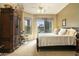 Cozy bedroom with a bed, ceiling fan, an armoire, and access to a balcony with neighborhood views at 5118 S Morning Sky Trl, Gold Canyon, AZ 85118
