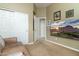 Bedroom with carpet, a comfy sofa, and large TV, offering a cozy entertainment space at 5118 S Morning Sky Trl, Gold Canyon, AZ 85118