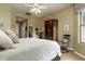 Comfortable bedroom featuring carpet, a large bed, ceiling fan, and an armoire next to a window at 5118 S Morning Sky Trl, Gold Canyon, AZ 85118