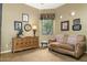 The cozy bedroom has a tan sofa, wooden dresser, and decorations, offering comfortable relaxation at 5118 S Morning Sky Trl, Gold Canyon, AZ 85118