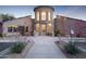 Contemporary home exterior showcasing stone accents, desert landscaping, and a decorative door at 5118 S Morning Sky Trl, Gold Canyon, AZ 85118