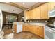Charming kitchen featuring ample cabinet space and an open layout to the dining area at 5118 S Morning Sky Trl, Gold Canyon, AZ 85118