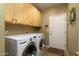 Functional laundry room with cabinetry, washer, and dryer for convenient chores at 5118 S Morning Sky Trl, Gold Canyon, AZ 85118