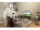 Bright living room with vaulted ceilings, large windows, stylish decor, and a comfortable leather sofa at 5118 S Morning Sky Trl, Gold Canyon, AZ 85118