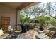 Relaxing covered patio with comfortable seating, barbecue grill, and desert landscaping at 5118 S Morning Sky Trl, Gold Canyon, AZ 85118