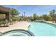Community pool deck, with seating, a hot tub and desert views beyond the fence at 5118 S Morning Sky Trl, Gold Canyon, AZ 85118