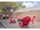 Outdoor living area with comfortable seating around a fire pit, mature trees, and a brick wall at 541 W Palm Ln, Phoenix, AZ 85003