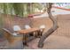 Charming backyard area with a wooden table and chairs, rock ground cover, and a mature tree at 541 W Palm Ln, Phoenix, AZ 85003