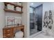 Stylish bathroom including a glass shower, decorative shelves, vanity area, and hexagon tiled floor at 541 W Palm Ln, Phoenix, AZ 85003