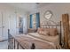 Comfortable bedroom with an iron bed frame, accent mirror, and built in storage at 541 W Palm Ln, Phoenix, AZ 85003