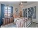 Inviting bedroom features an iron bed frame, modern artwork, and blue curtains at 541 W Palm Ln, Phoenix, AZ 85003