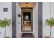 Elegant entryway featuring a stylish 'hello' mat, black trim, and a glimpse of the interior decor at 541 W Palm Ln, Phoenix, AZ 85003