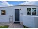 Charming front exterior featuring a dark-colored door, decorative lamp, and well-maintained landscaping, enhancing curb appeal at 541 W Palm Ln, Phoenix, AZ 85003