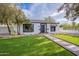 Inviting single-story home with a well-manicured lawn and a cozy, classic design at 541 W Palm Ln, Phoenix, AZ 85003