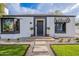 Well-maintained single-story home with landscaped front yard and traditional black and white awning at 541 W Palm Ln, Phoenix, AZ 85003