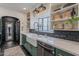 Stylish kitchen with white marble countertops, farmhouse sink, open shelving, and black brick backsplash at 541 W Palm Ln, Phoenix, AZ 85003