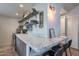 Kitchen with marble countertops, open shelving displaying dishes, and bar seating for casual dining at 541 W Palm Ln, Phoenix, AZ 85003